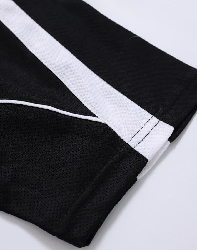 A close-up of a black polo shirt featuring white accents and a logo.