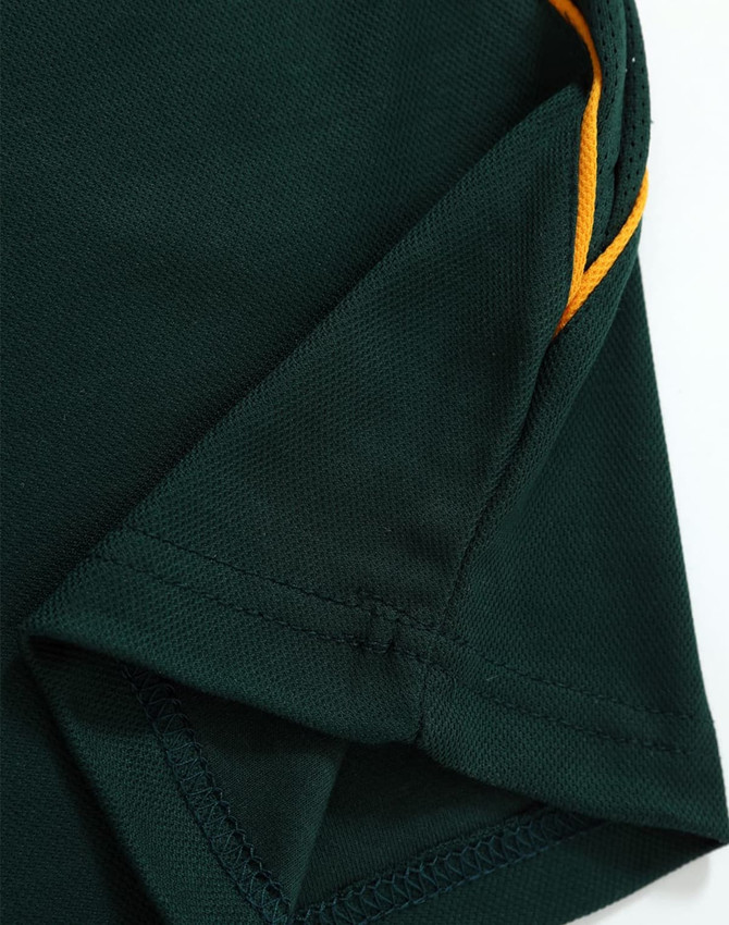 A green polo shirt with yellow detailing and a textured fabric, featuring a logo on the side.