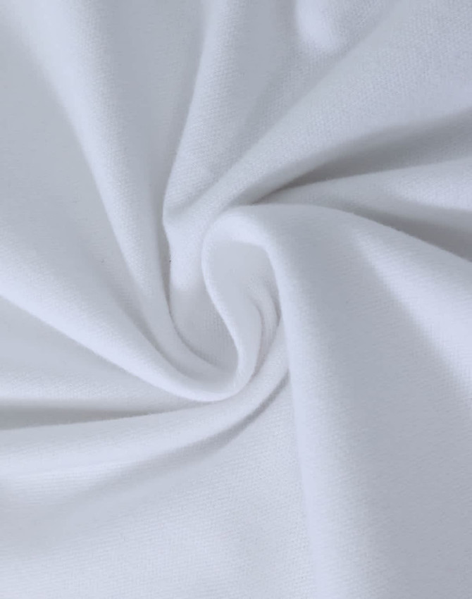 A close-up view of soft, white cotton fabric, showcasing a smooth and stretchy texture.
