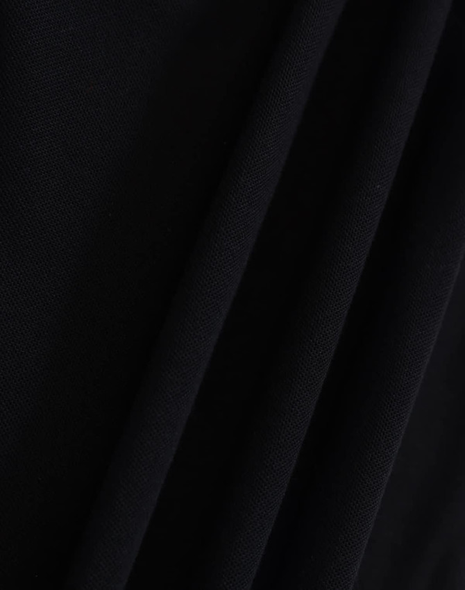 A close-up of a black fabric with a textured surface, featuring folds and draping. The image showcases the material's quality.