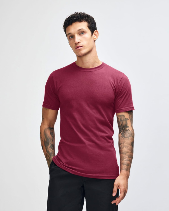 A maroon unisex short sleeve t-shirt with a crew neck, featuring a logo on the upper left chest.
