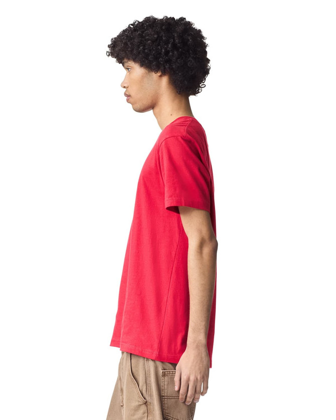 A red unisex short sleeve t-shirt displayed on a model from the side, featuring a branding logo.