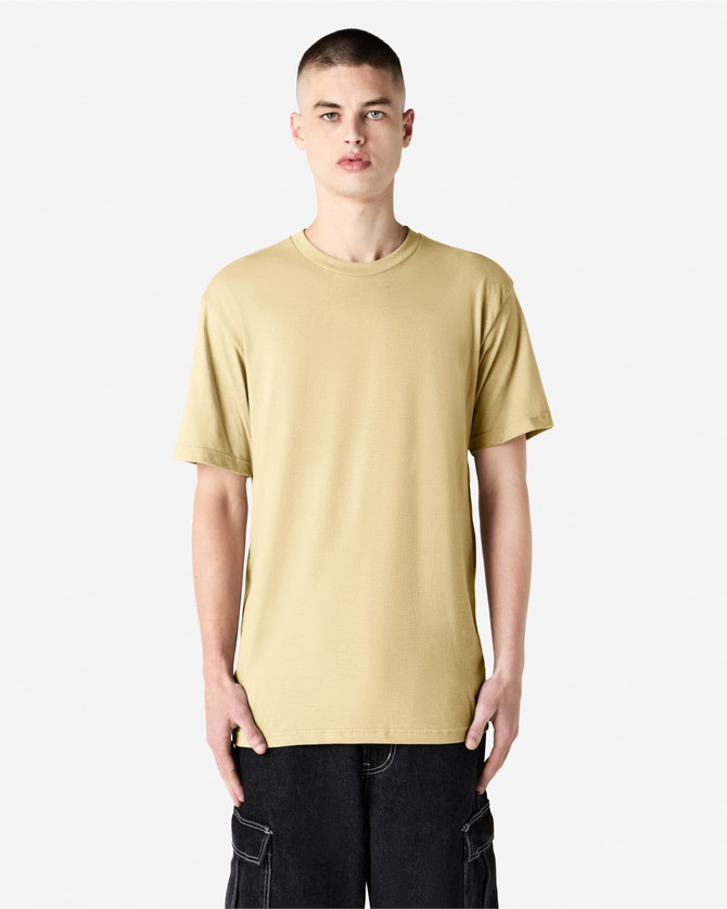 A unisex short sleeve t-shirt in a pale yellow colour, displayed on a model against a plain background.