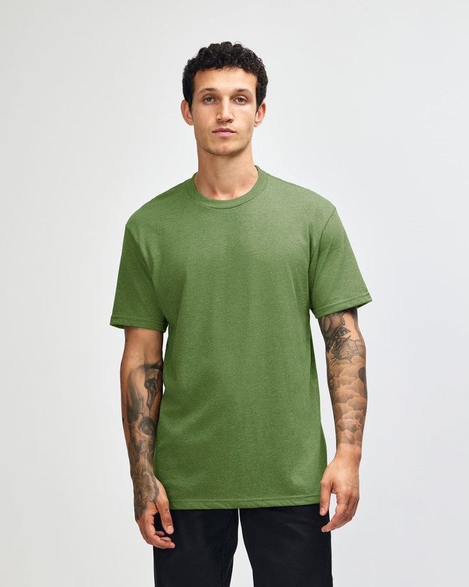 A unisex short sleeve T-shirt in a vibrant green colour, displayed on a model standing against a plain background.