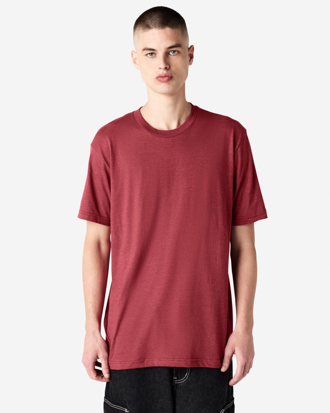 A unisex CVC short sleeve T-shirt in a rich burgundy colour, displayed on a model. Features a logo.