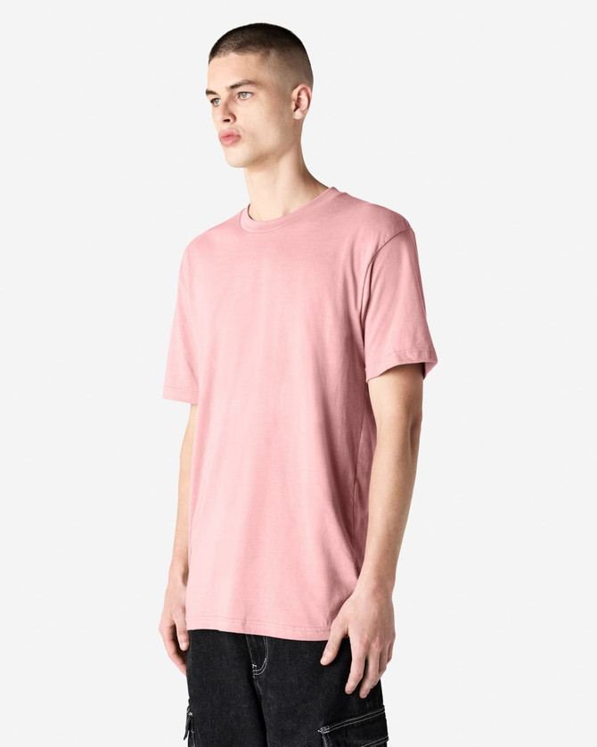 A unisex short sleeve T-shirt in soft pink, featuring a relaxed fit and a logo on the brand label.
