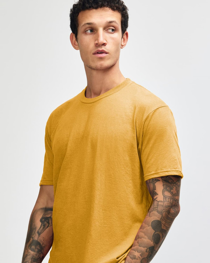 A unisex short sleeve t-shirt in a mustard yellow colour, featuring a simple design and a logo.