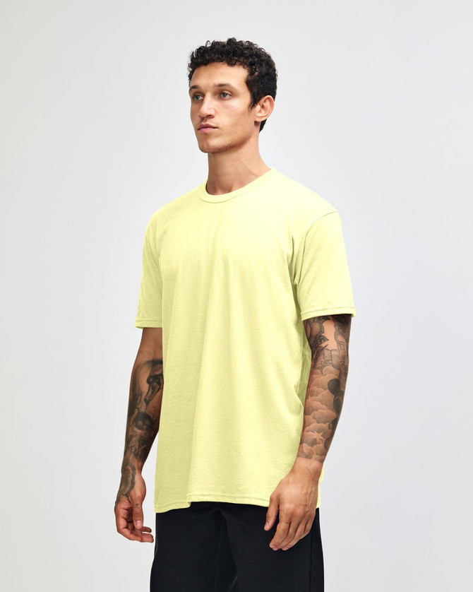 A unisex CVC short sleeve t-shirt in bright yellow, displayed on a model against a neutral background.