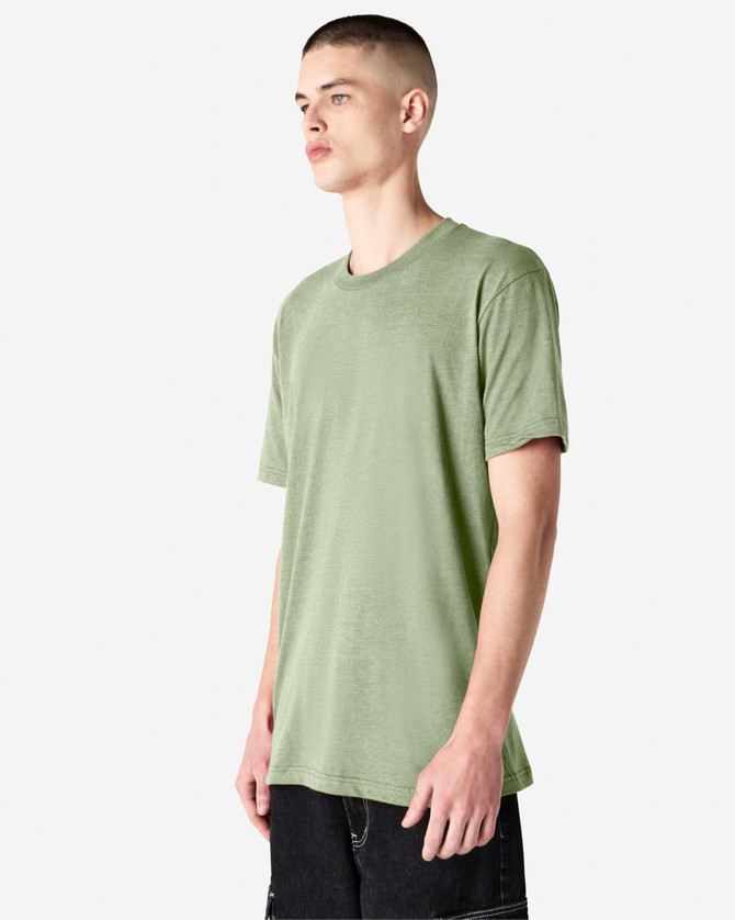 A green unisex CVC short sleeve T-shirt displayed on a model, featuring a subtle texture and relaxed fit.