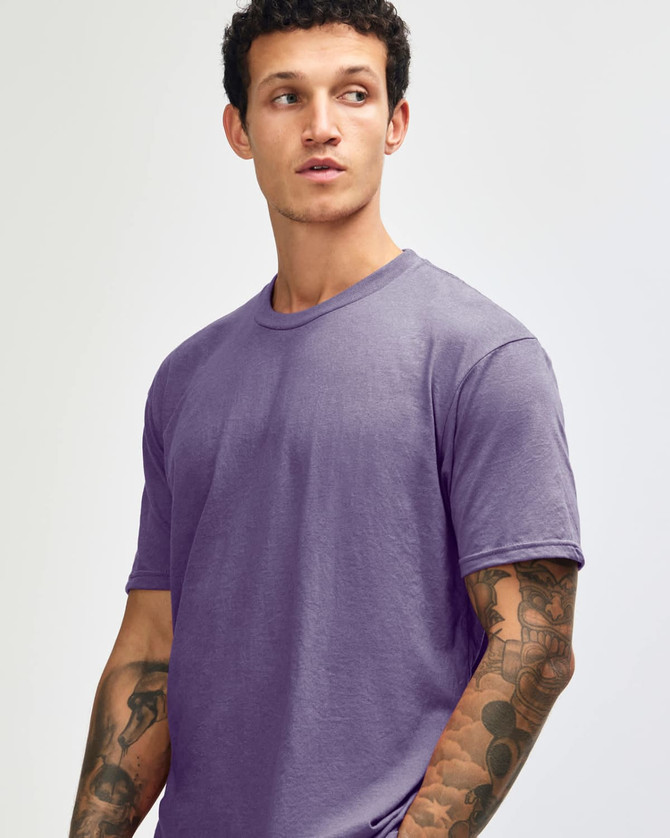 A unisex short sleeve t-shirt in a purple hue, featuring a simple design and a logo.