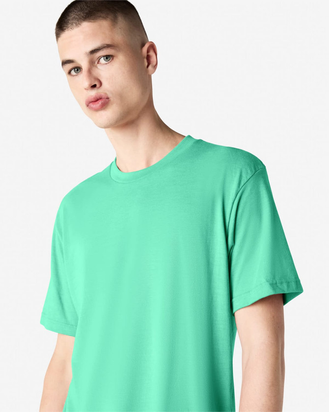 A model wearing a unisex short sleeve T-shirt in vibrant mint green, featuring a logo on the sleeve.