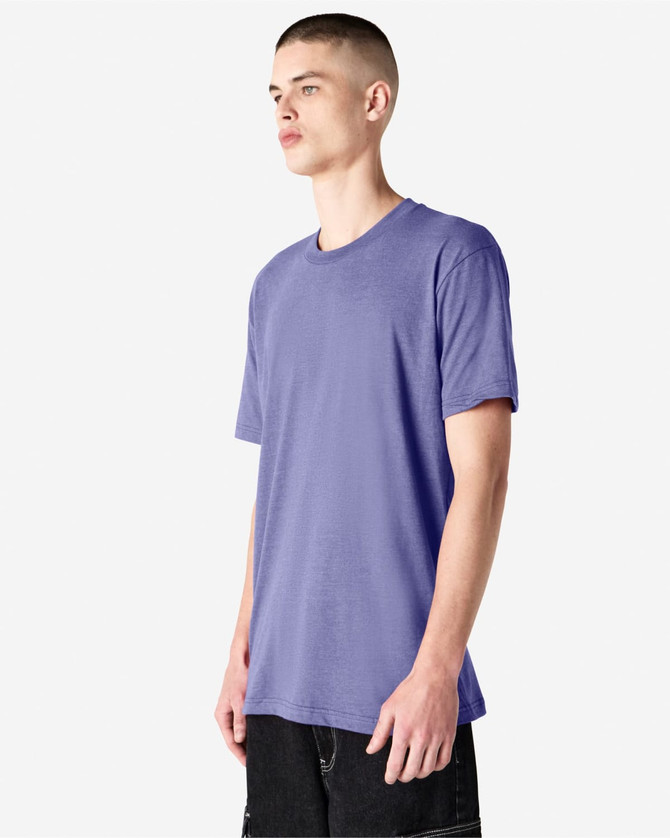 A unisex short sleeve t-shirt in a light purple hue, displayed on a model in a neutral background.