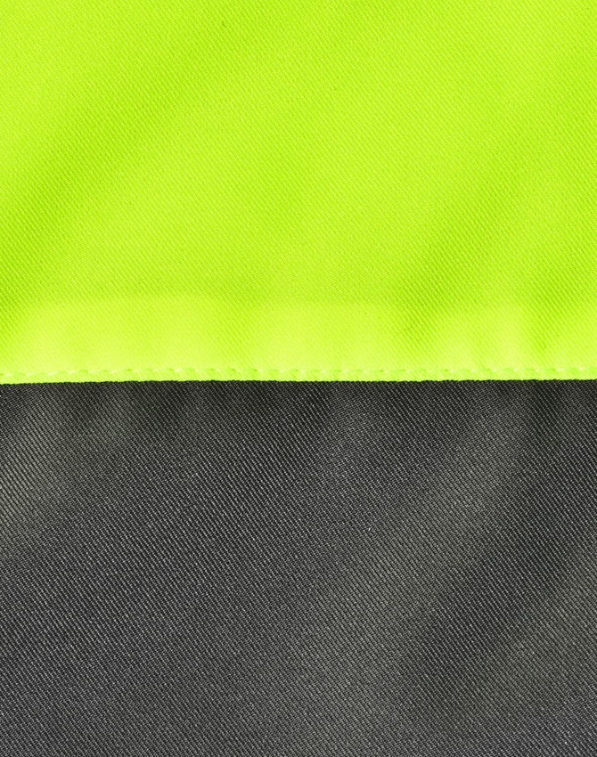 A close-up of a hi-vis quilted safety jacket featuring fluorescent yellow and dark grey sections, plus visible stitching.