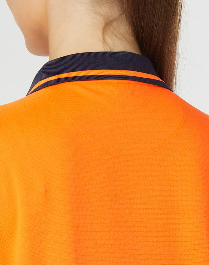 A close-up of a bright orange polo shirt with a navy collar and stripes, featuring a logo.