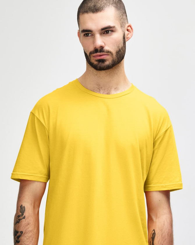 A man wearing a bright yellow Gildan Softstyle adult T-shirt, featuring a round neckline and short sleeves.