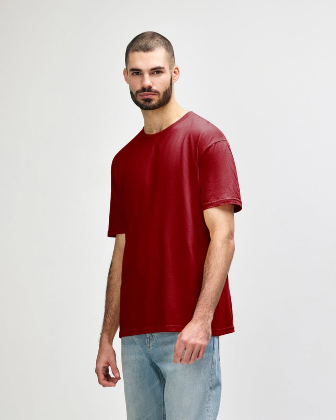 A red Gildan Softstyle adult t-shirt displayed on a model, featuring short sleeves and a relaxed fit.