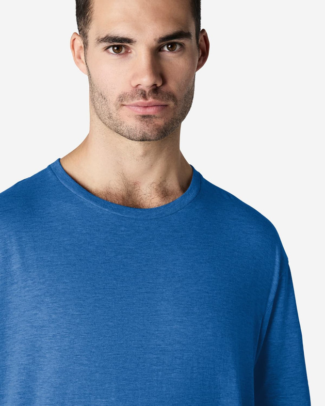 A blue Gildan Softstyle adult T-shirt displayed on a male model with a neutral expression.