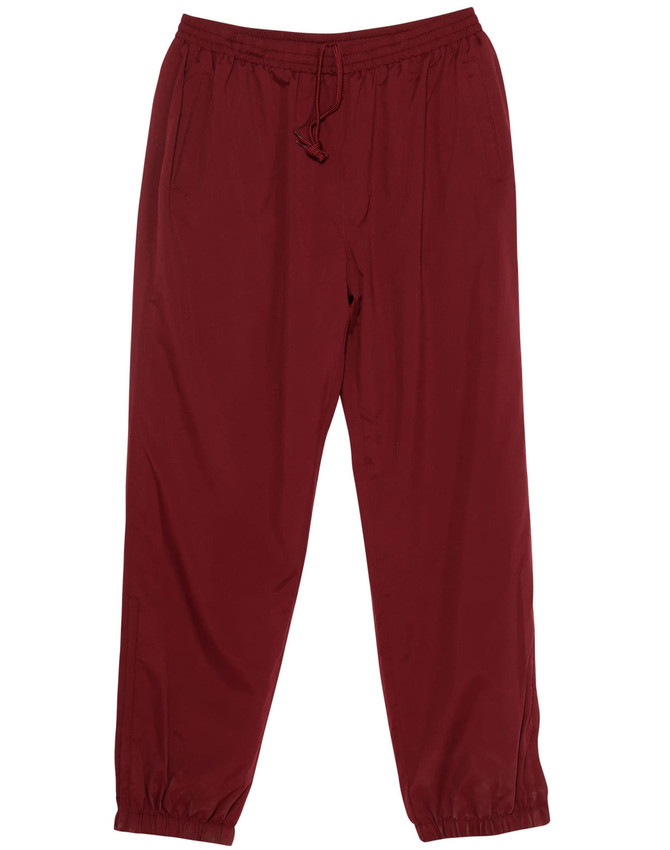 Burgundy warm-up pants featuring an elastic waistband, two pockets, and a logo. Designed for comfort and movement.