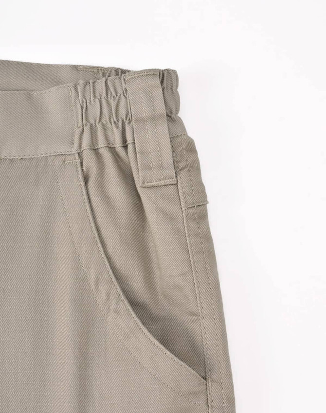 Unisex cotton stretch ripstop work pants in light khaki with an elastic waistband and side pocket detail.