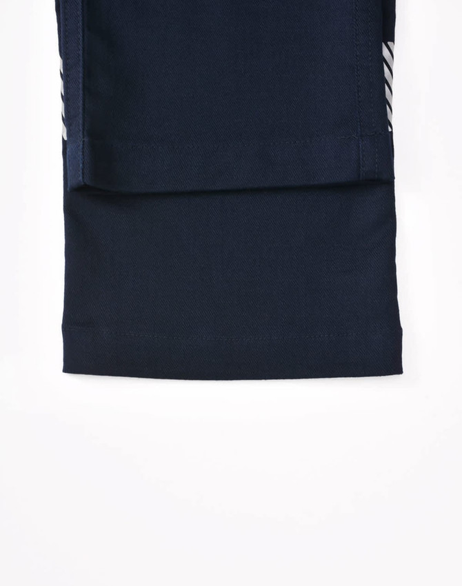 A pair of navy blue unisex cotton stretch ripstop segmented work pants, featuring a fold-over leg design.