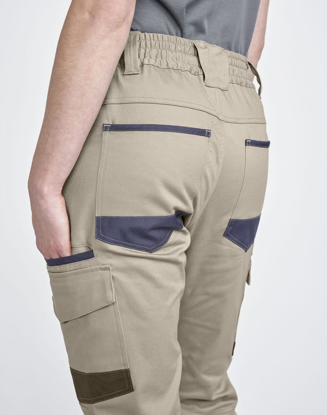 Unisex cotton stretch drill cuffed work pants in beige with navy accents and pockets, featuring an elastic waistband.