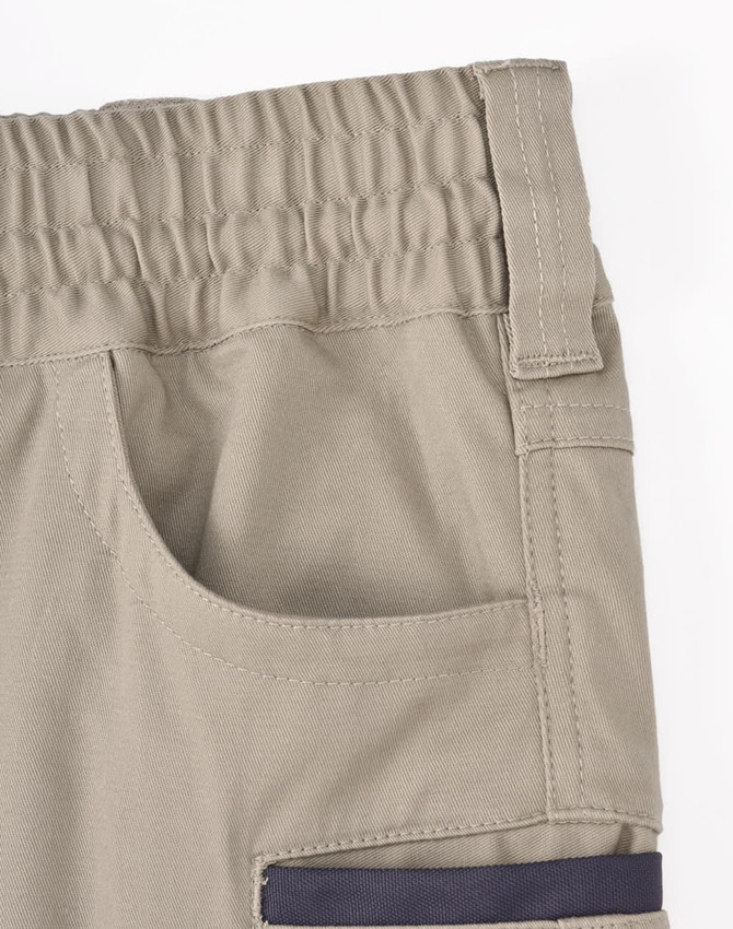 Unisex cotton stretch drill work shorts in beige, featuring an elastic waistband and a side pocket.