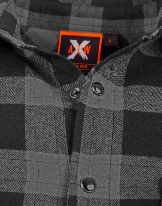 A black and grey plaid unisex flannel button-up shirt featuring a logo on the label.