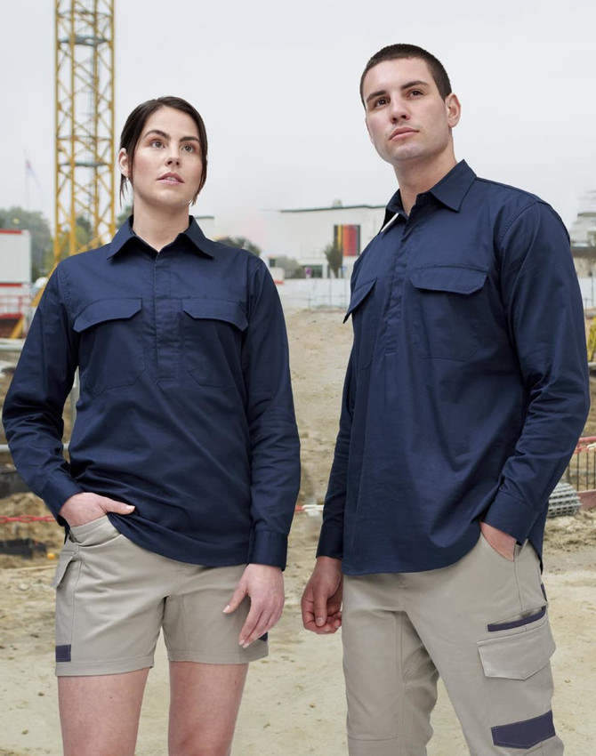 A closed front long sleeve work shirt in navy, displayed on a male and female model in a construction setting.
