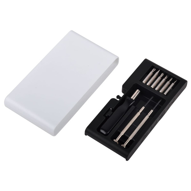 A tool set in a compact white case, featuring various metal tools in a black compartment.