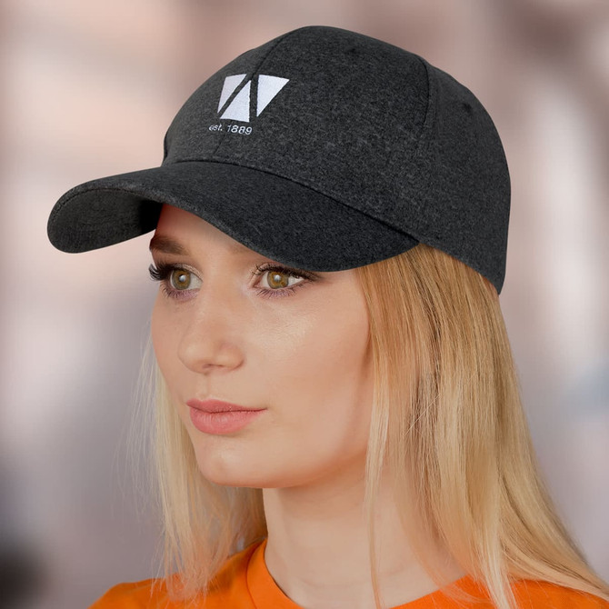A dark grey cap with a curved brim and a logo on the front, modelled by a woman with long blonde hair.