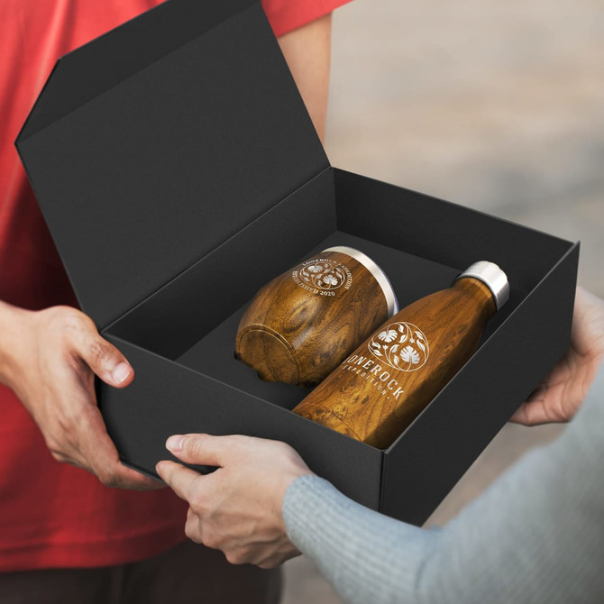 A gift set containing two vacuum drink bottles in wood and silver finishes, presented in a black box.