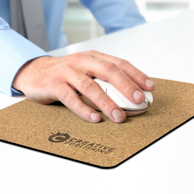 A hand using a white mouse on a cork-coloured mouse mat featuring a logo.