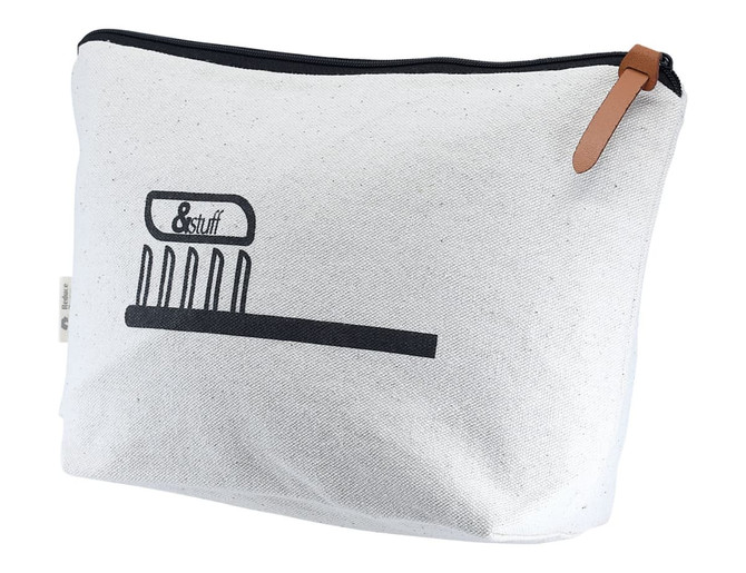 A calico toiletry/makeup bag in white with a black graphic and a brown leather zipper pull.