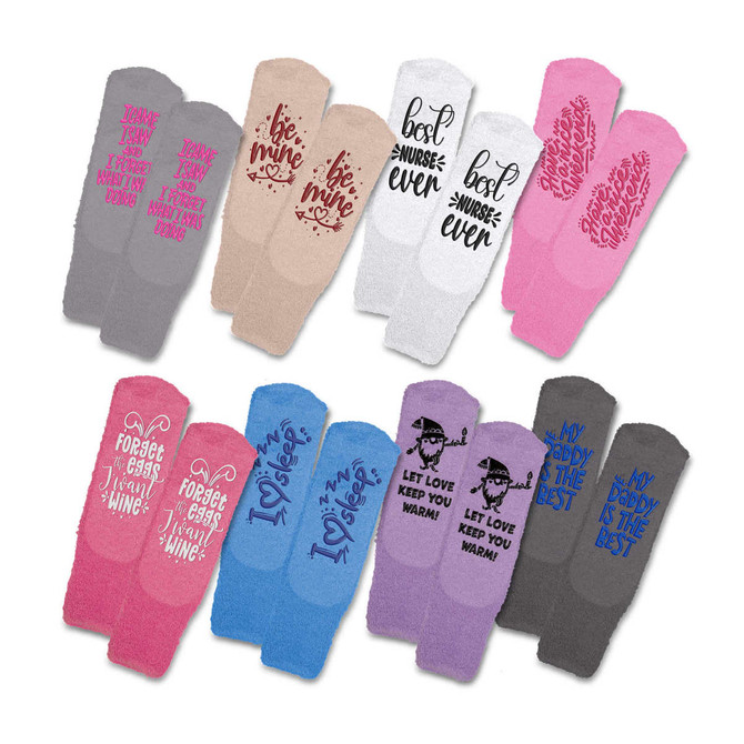 Fluffy grip socks in various colours including pink, grey, and beige, with whimsical text designs.