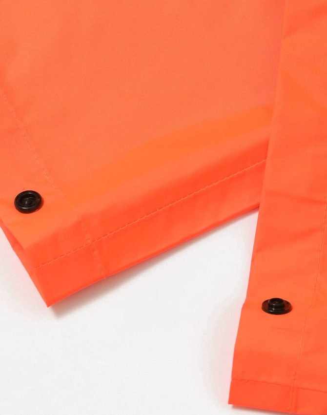 Bright orange lightweight nylon waterproof rain pants, featuring snap fasteners at the openings. Includes a logo.