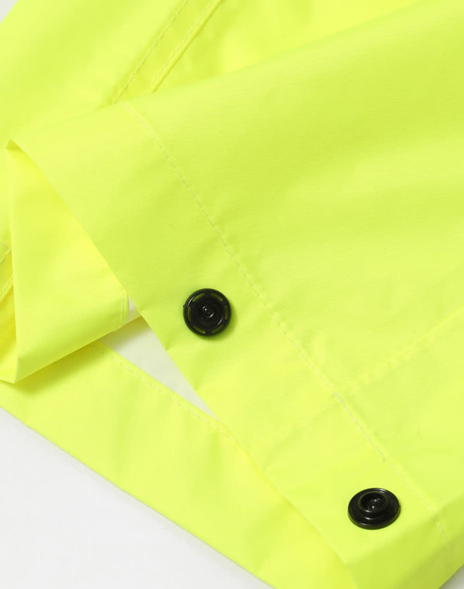 Bright yellow lightweight nylon waterproof rain pants with black buttons. Features a smooth, shiny finish.