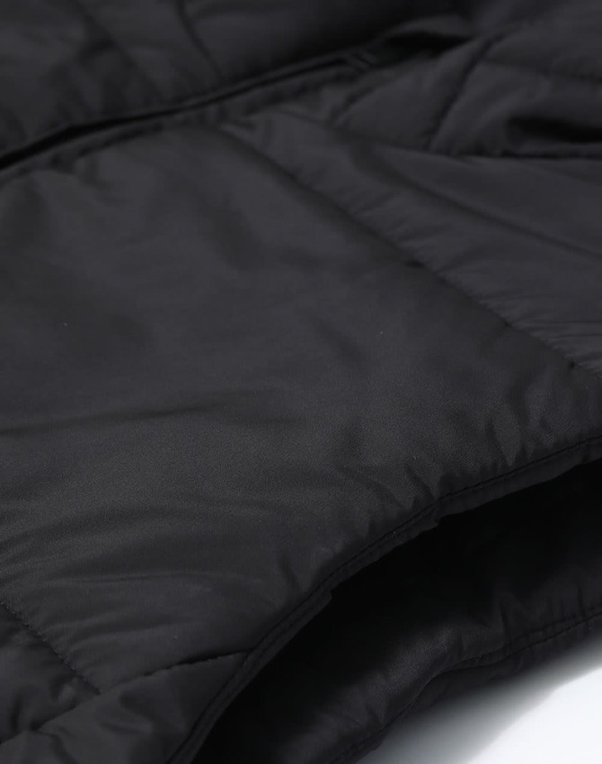 A black men's sustainable insulated puffer vest featuring a 3D cut design and visible stitching details.