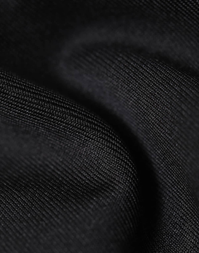 A close-up of a black softshell fabric, showcasing its smooth, textured surface. The material appears durable and flexible.
