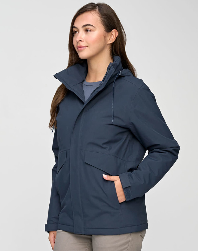 A unisex quilted waterproof jacket in navy, featuring a hood and front pockets, worn by a model.