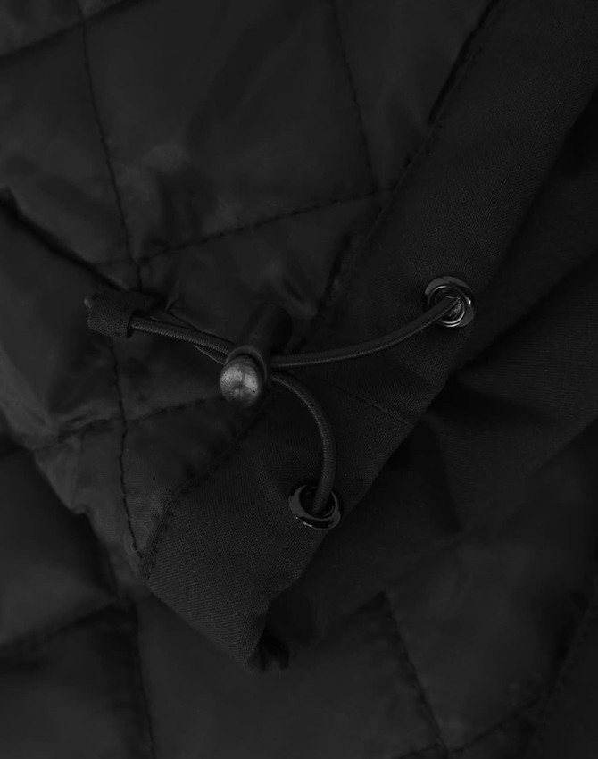 A close-up of a black quilted waterproof jacket featuring adjustable drawstrings. It includes a logo.