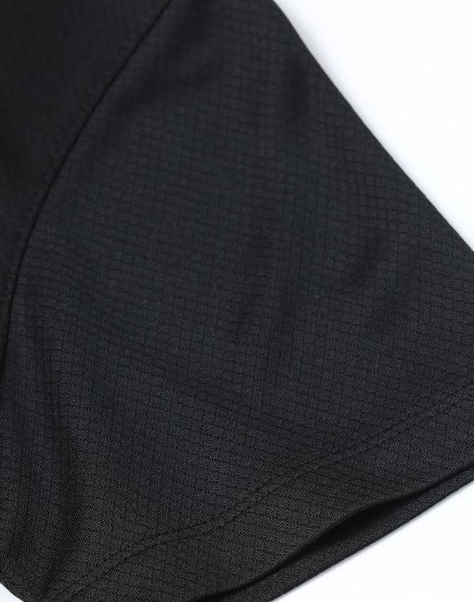 A close-up of a black sustainable jacquard knit polo shirt featuring textured fabric and short sleeves.