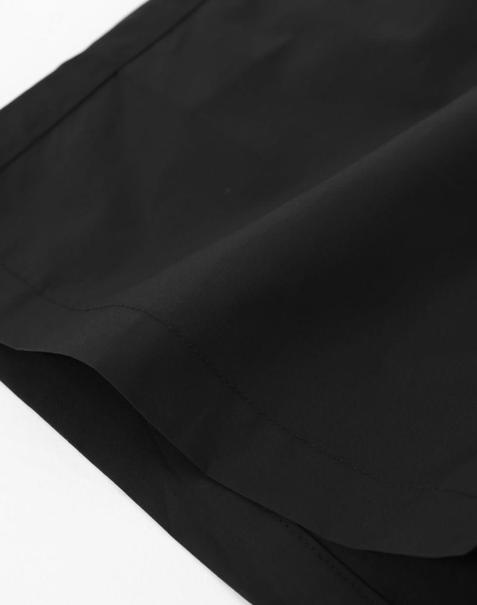 Black unisex mercerised cotton shorts displayed, featuring a smooth fabric texture and a hemmed finish.