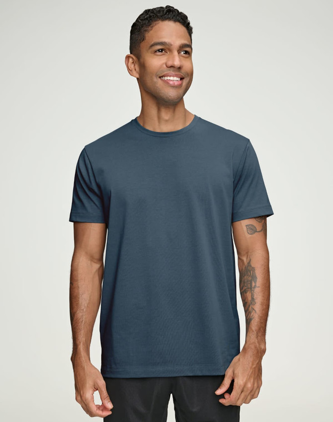 A navy blue men's premium cotton short sleeve t-shirt displayed on a smiling male model, featuring a logo.