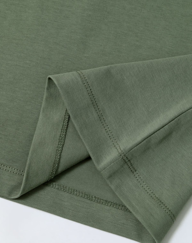 A green premium cotton short sleeve tee shirt, featuring neatly stitched hems and a soft fabric texture.