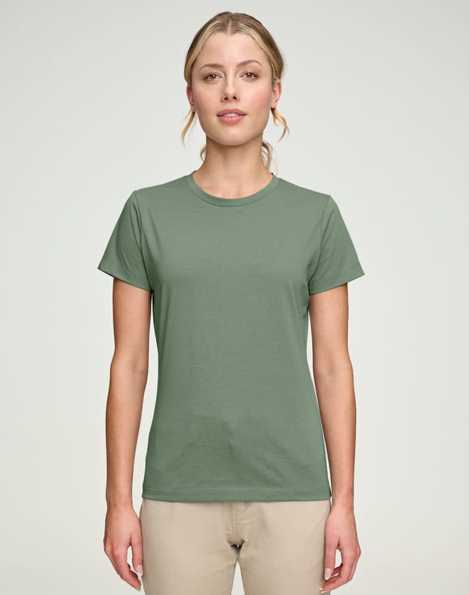 A green ladies' premium cotton short-sleeve tee shirt displayed on a model, featuring a simple design and a logo.