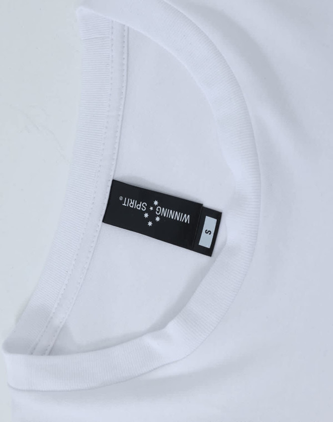 A white long-sleeve tee with a round neckline, featuring a label and a logo.