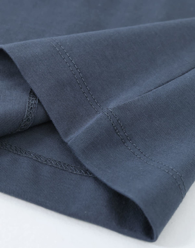 A close-up of a ladies' premium cotton long sleeve tee shirt in navy blue, featuring neatly finished hems and stitching.