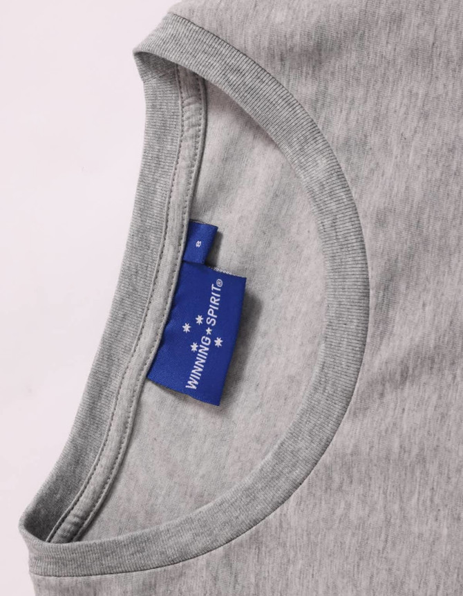 A grey ladies' long sleeve cotton tee shirt featuring a crew neck and a tag with branding.