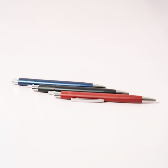 A set of three pens in blue, black, and red, featuring silver accents and clips. The pens are arranged in a row against a white background.