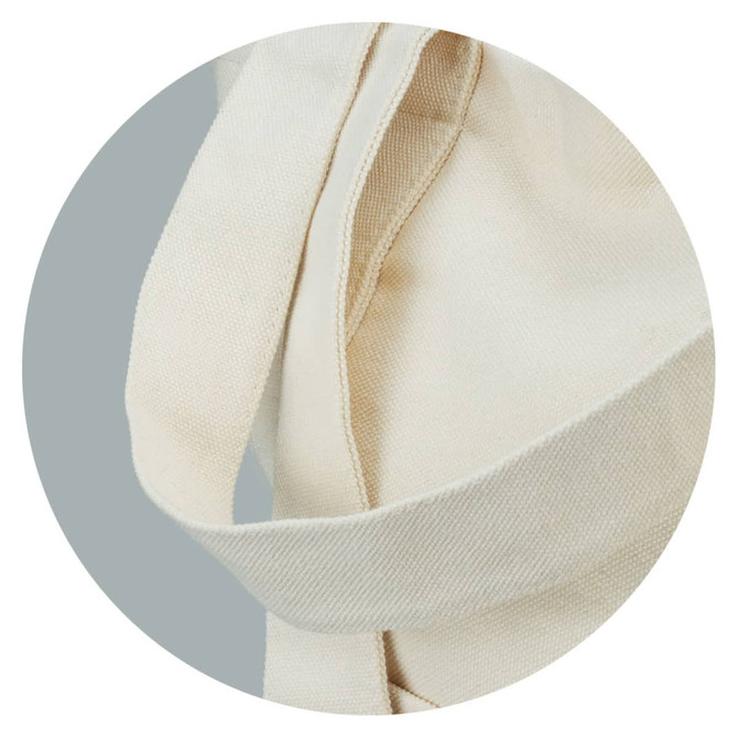 A cream canvas tote bag with sturdy straps, featuring a seamless design and soft texture.